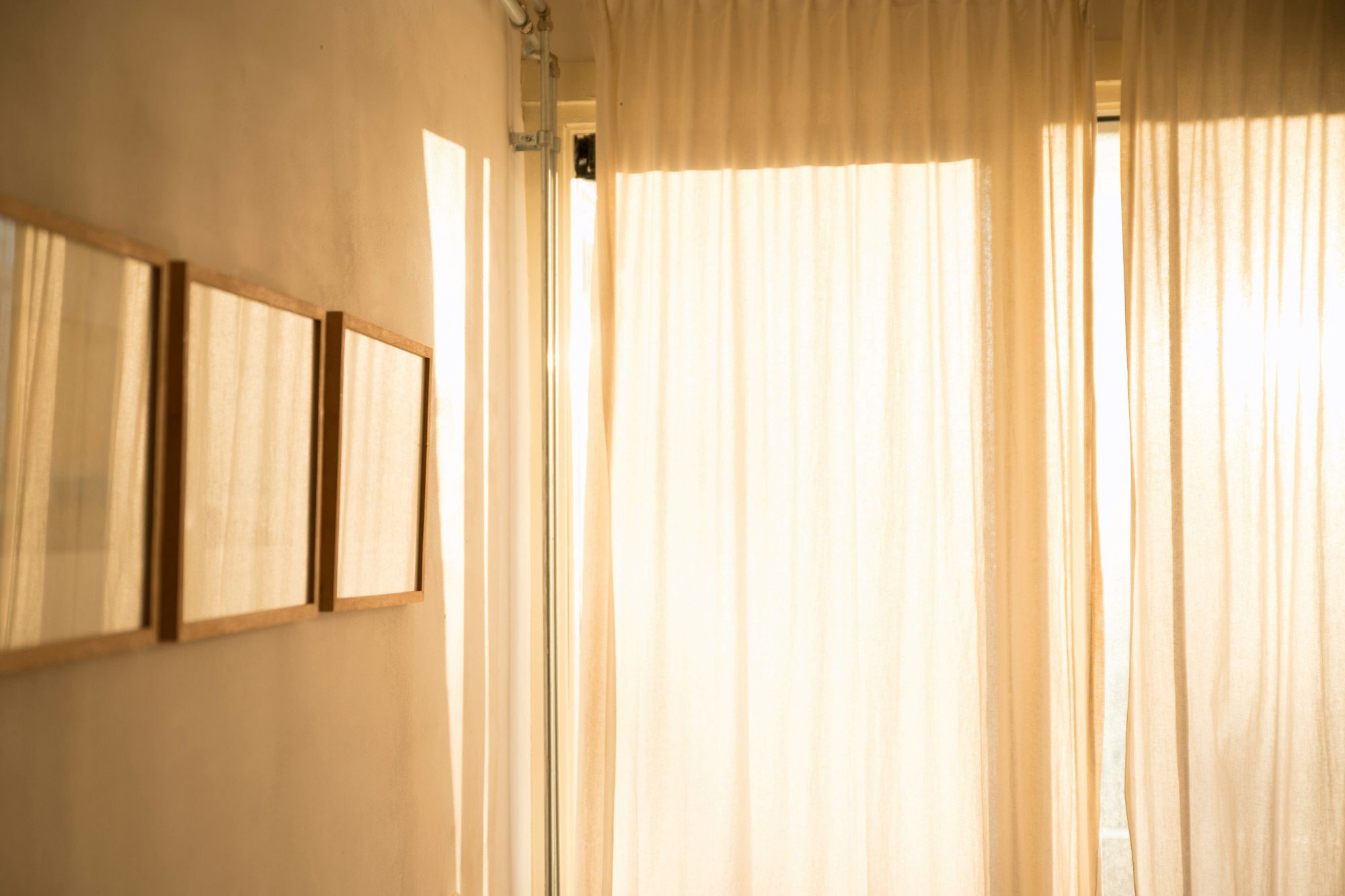 A quiet room with sheer white curtains and soft window light